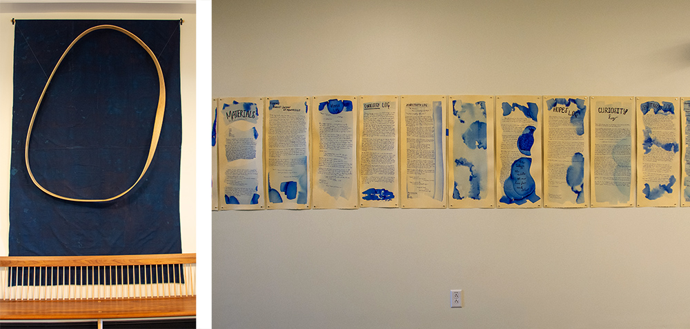 Two images: One shows a circular piece of wood bent in an organic shape on top of a soft blue cloth. The other shows many panels of cream-colored paper with splotches of rich blue paint and words written across the pages