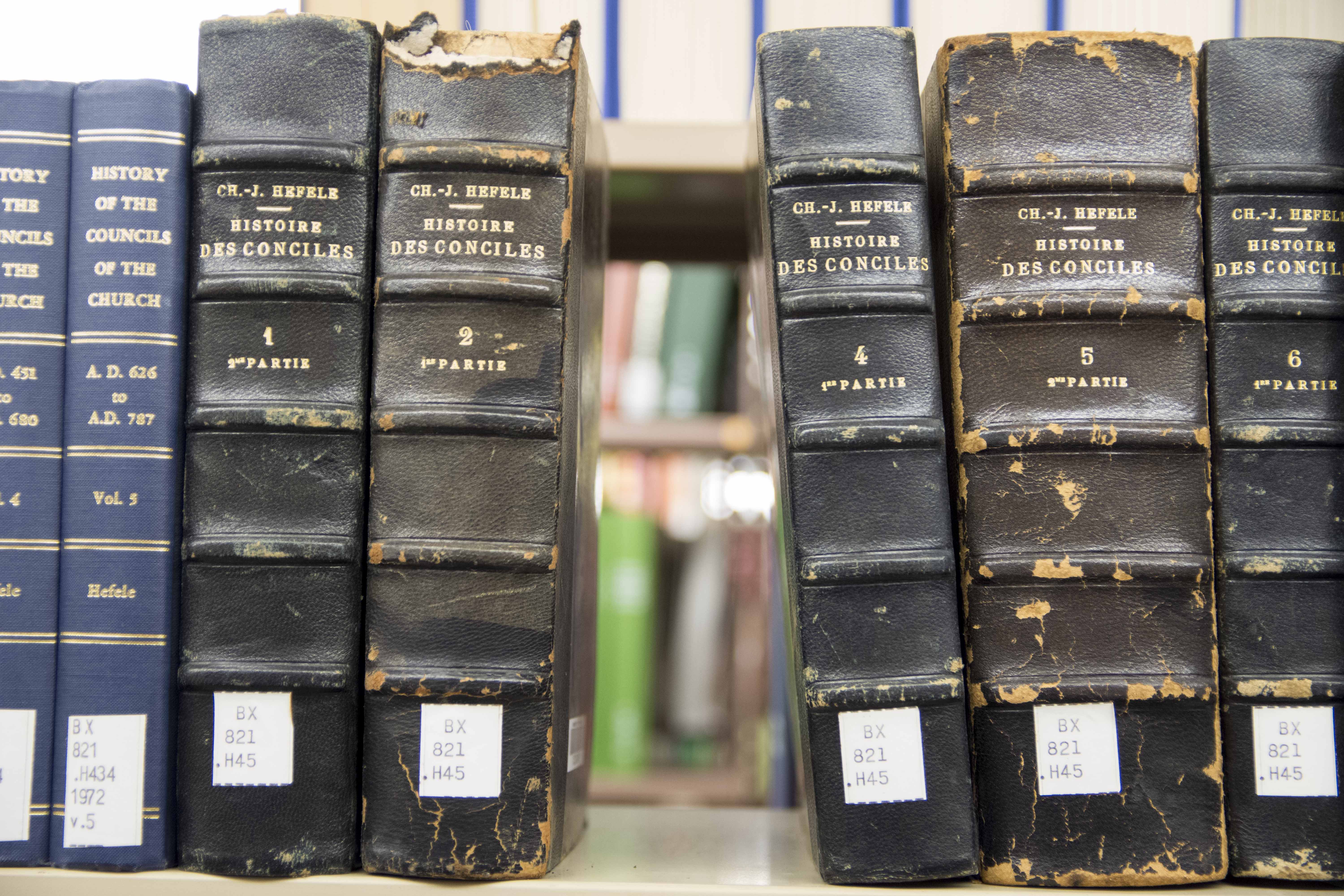 Volumes on bookshelf with one volume missing in the middle